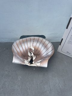 Biodegradable clam urn after being opened for ash scattering